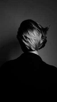 a black and white photo of a woman's back