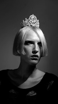 a black and white photo of a woman wearing a tiara