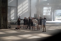 a group of people standing in a warehouse