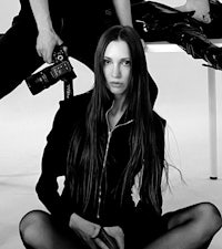 a black and white photo of a woman posing for a photographer